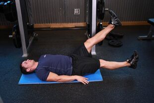 Man with prostatitis does exercise at the gym